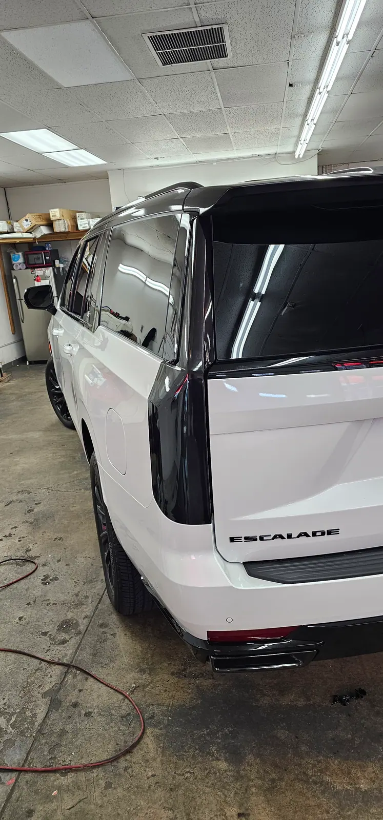 White Cadillac Escalade with tinted rear glass