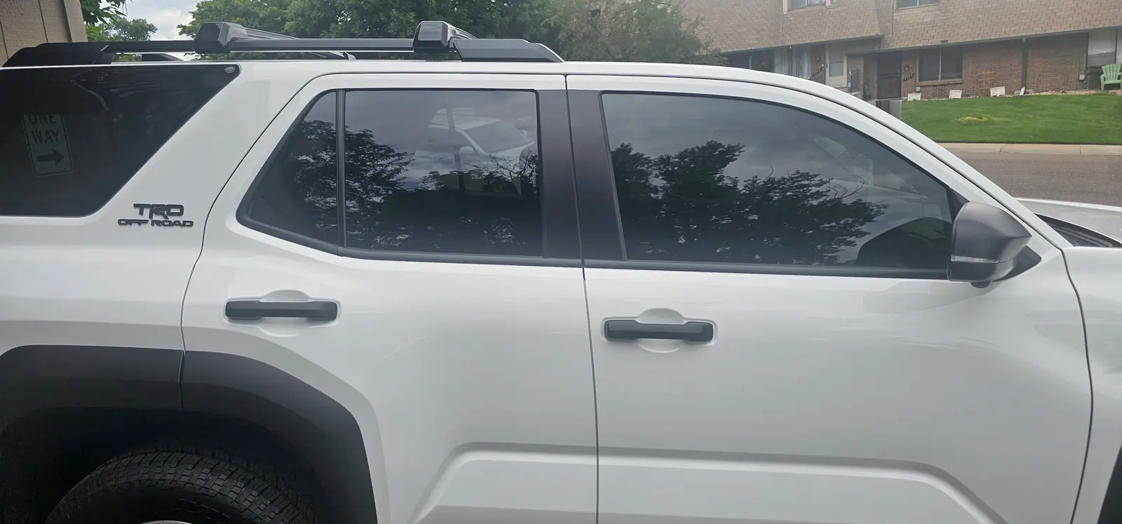 White Toyota SUV tinted along the full side glass