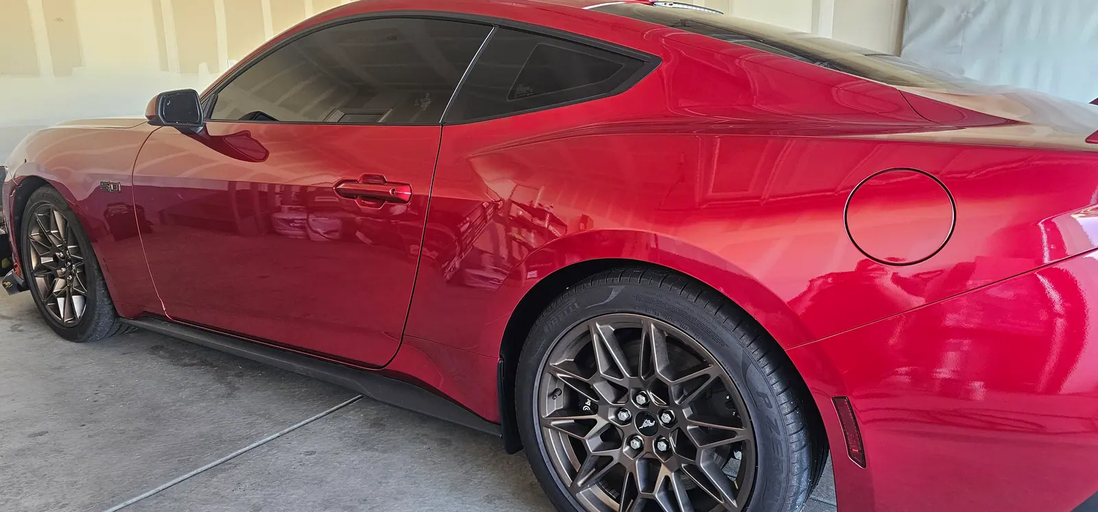 Red Mustang GT, coated flank catching the light