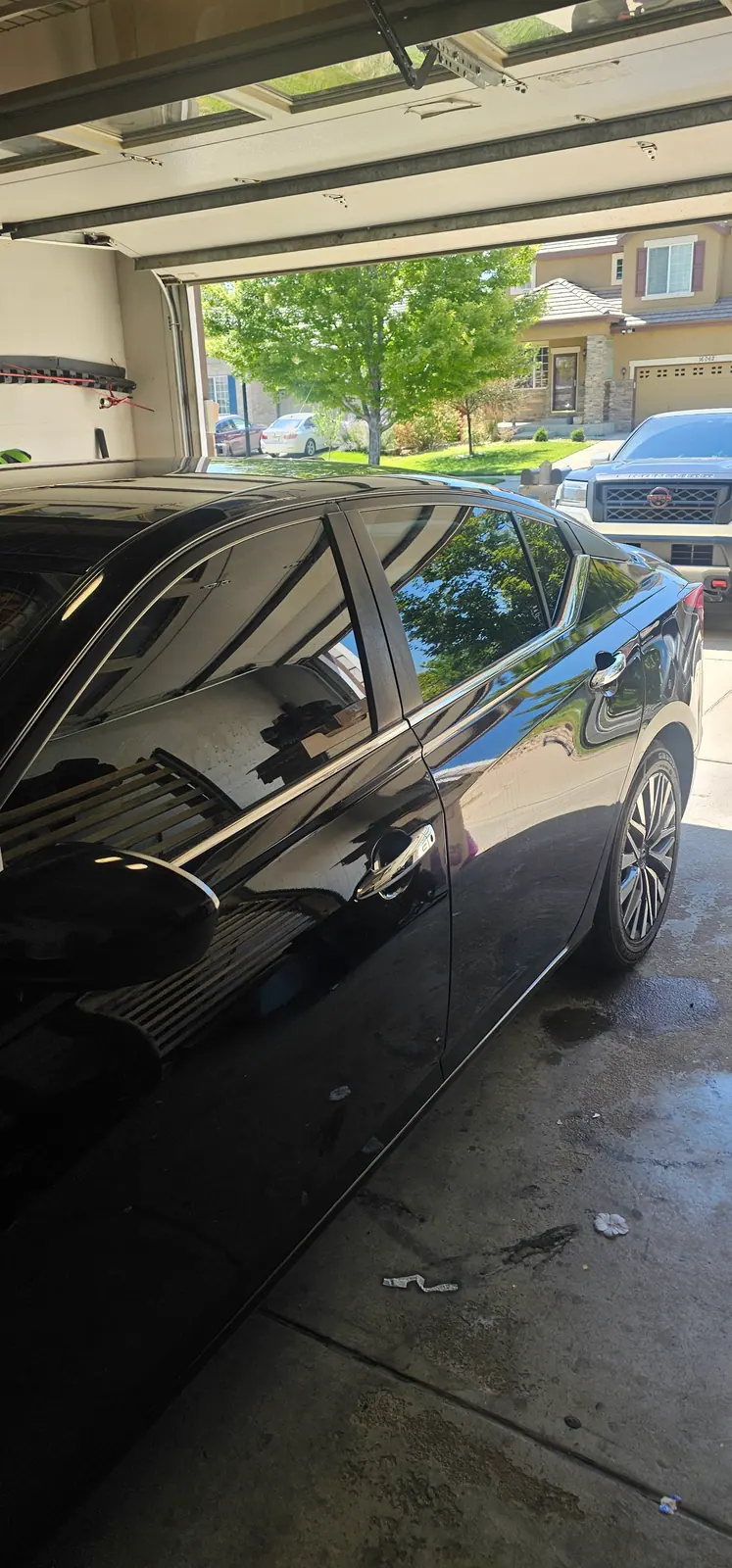 Black sedan with freshly tinted rear door glass
