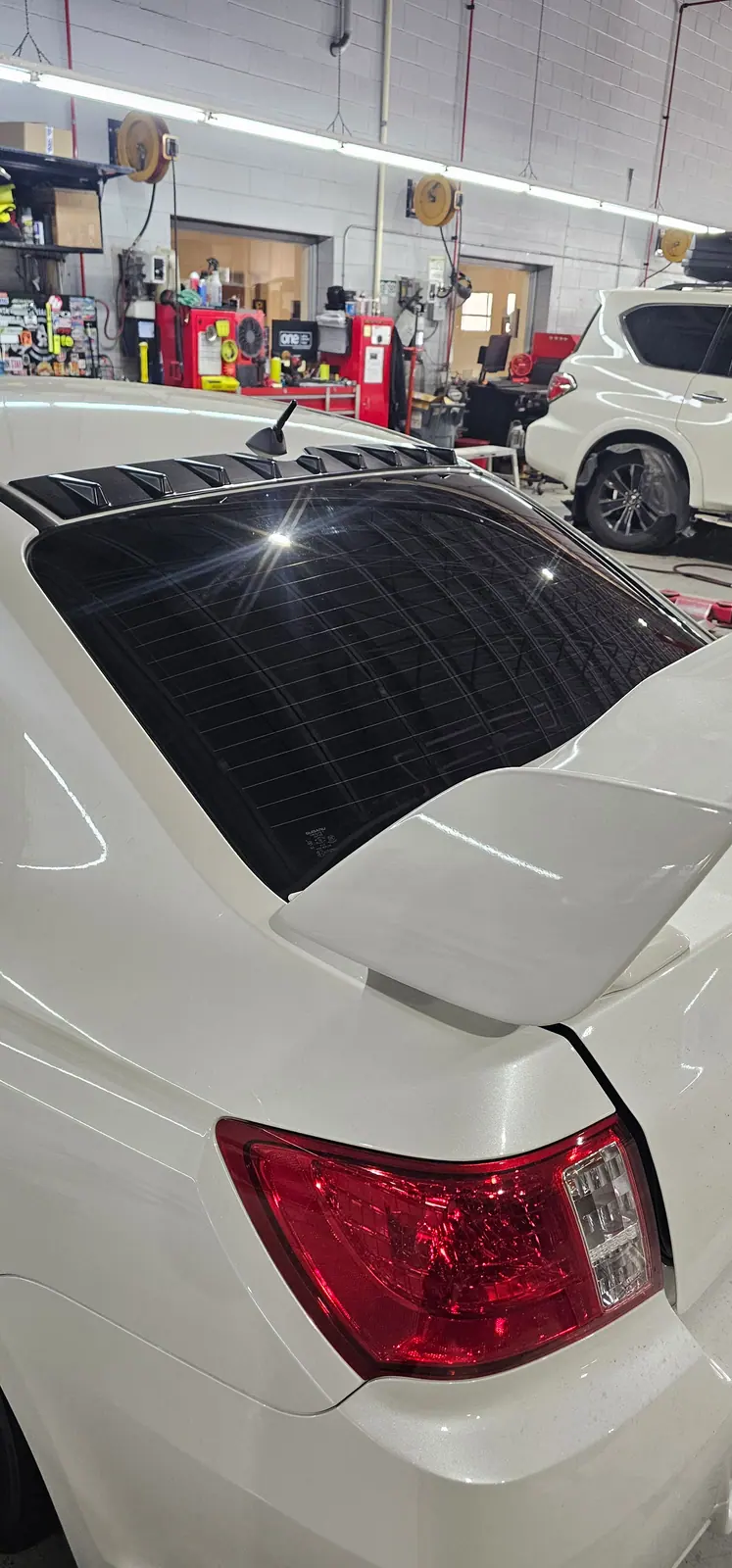 Rear glass tint on a white Subaru wagon
