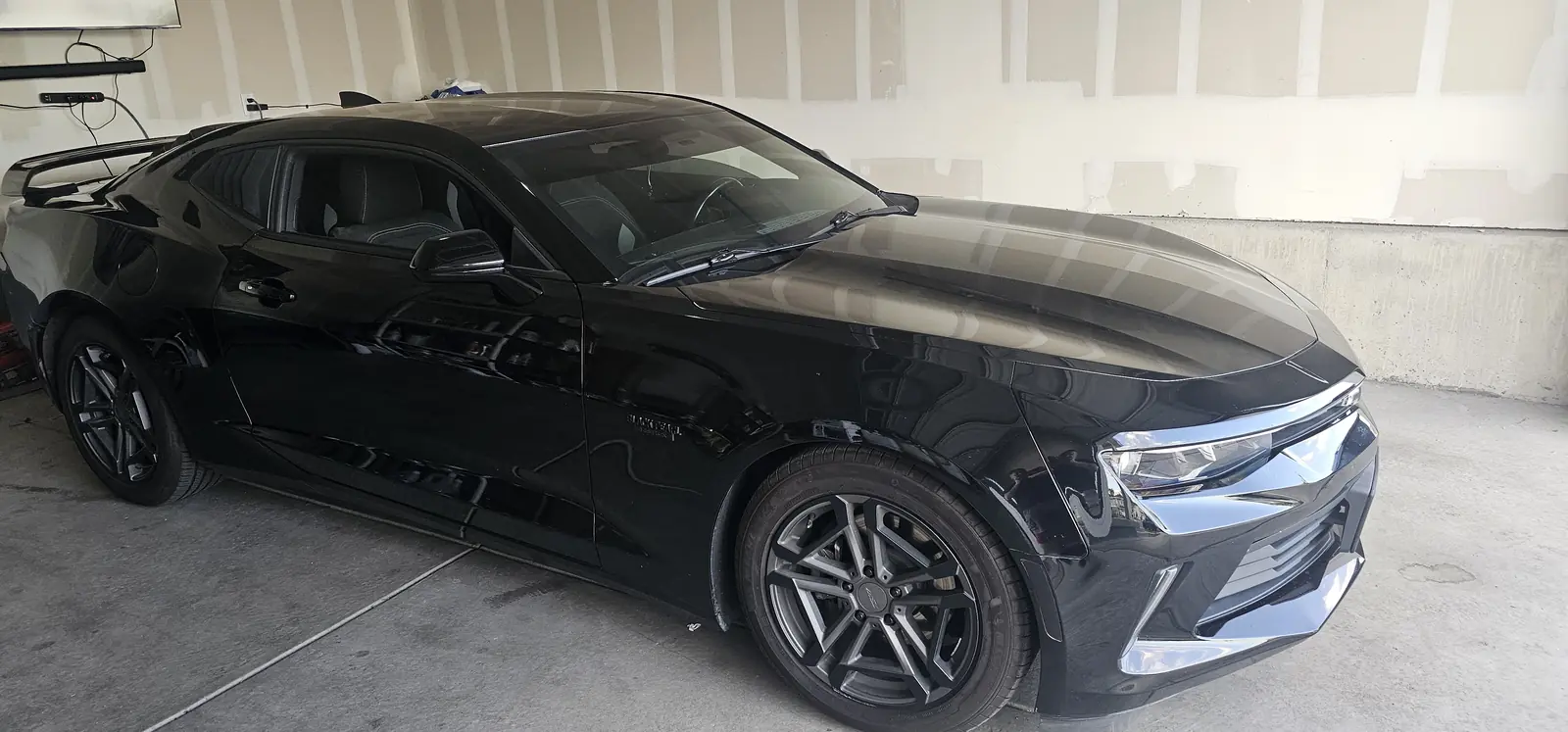 Black coupe with a glossy hood after coating