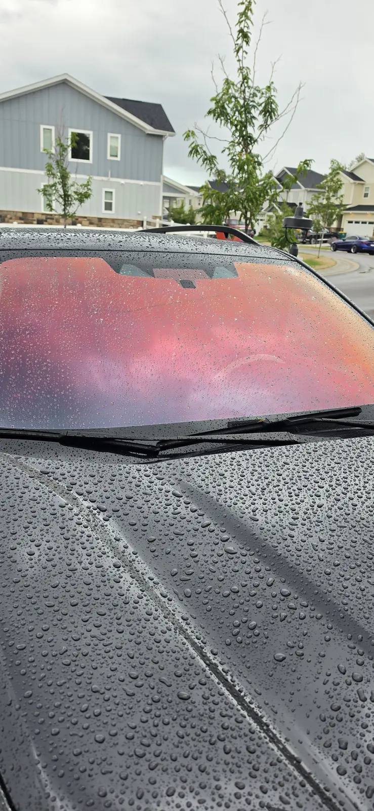 Rain beading straight off the glass and paint of a ceramic coated car