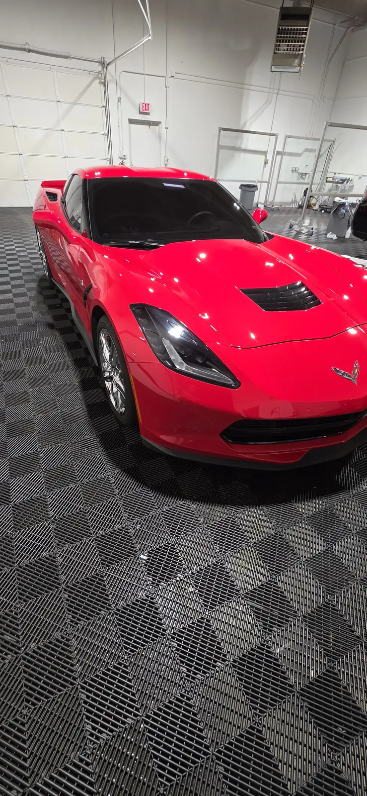 Nose of the coated red Corvette Stingray on the shop floor