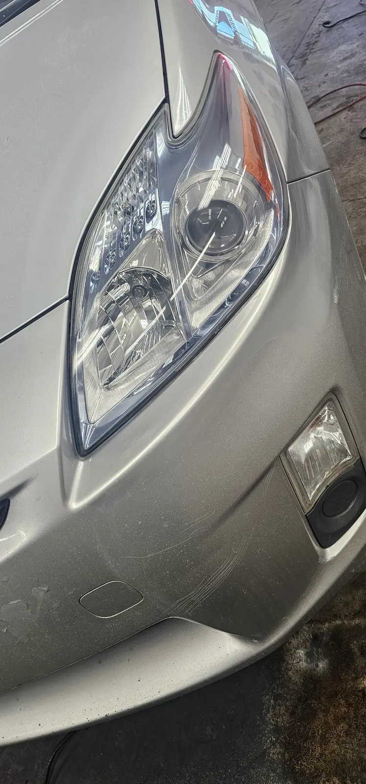 Headlight lens restored to clear, cut back from the yellowed original
