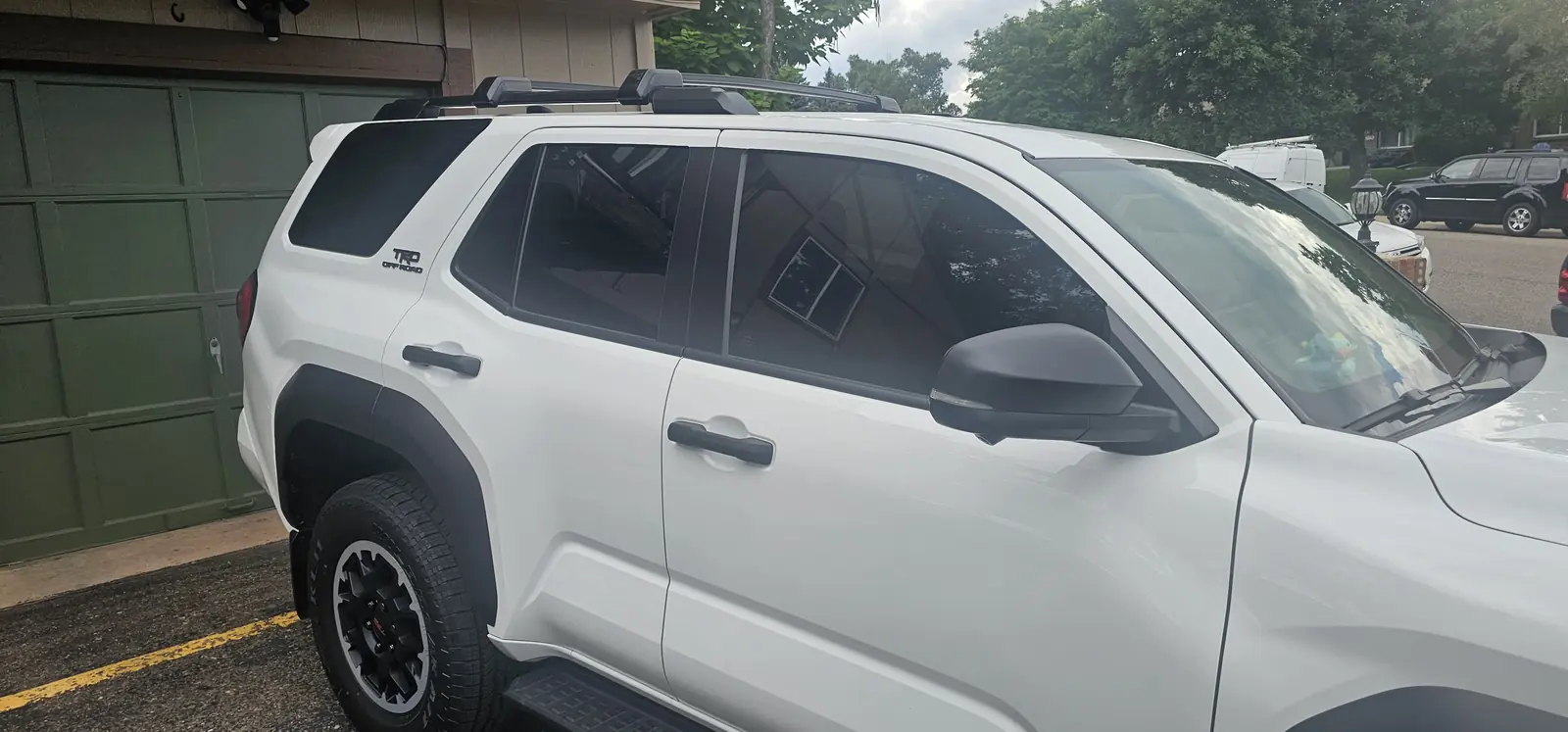 White SUV with tinted side windows, driver side view