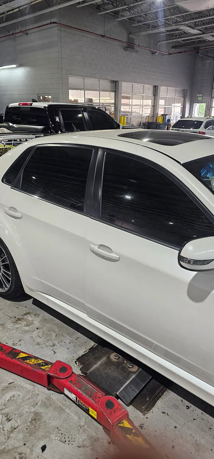 White Subaru wagon with tinted side glass