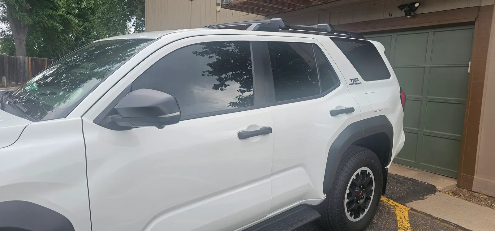 White Toyota SUV, tinted front and rear door glass